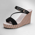 ZOFIA ATELIER black suede slope heel sandals with woven platform and ankle strap.