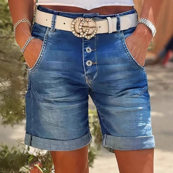 ZOFIA ATELIER RENATA high-waist denim crop shorts with rolled hem, button fly, and elastic waistband. Blue wash.