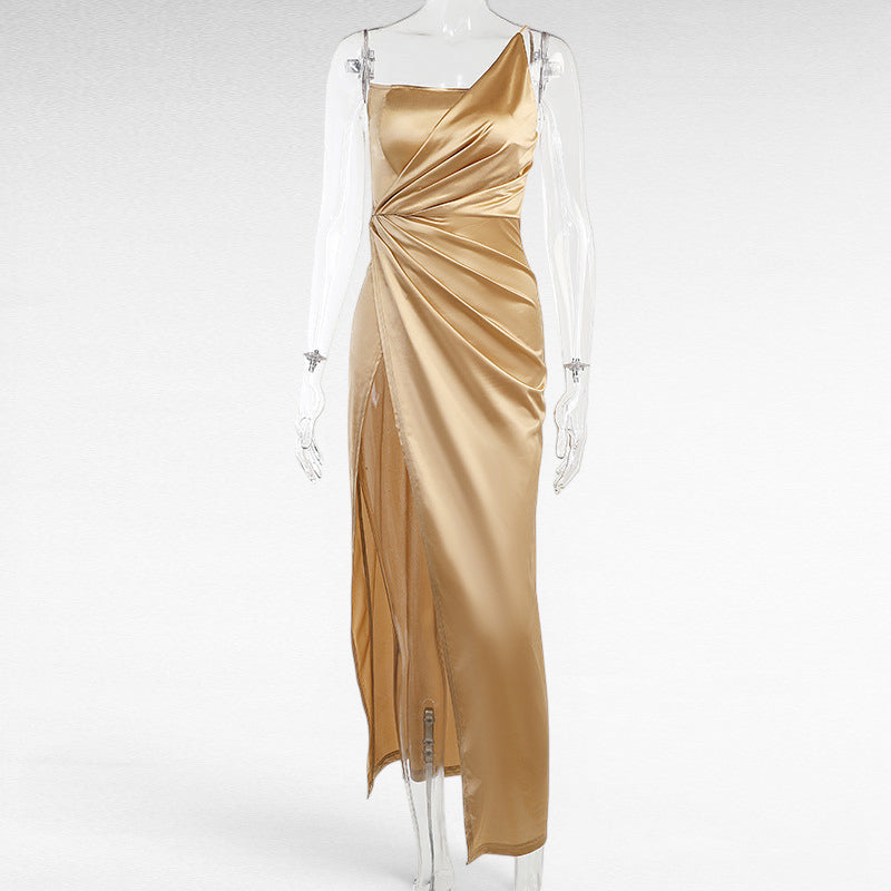 ZOFIA ATELIER gold satin woven dress with oblique shoulder, ruched detail, and high slit. Sleeveless, high-waisted, maxi length.