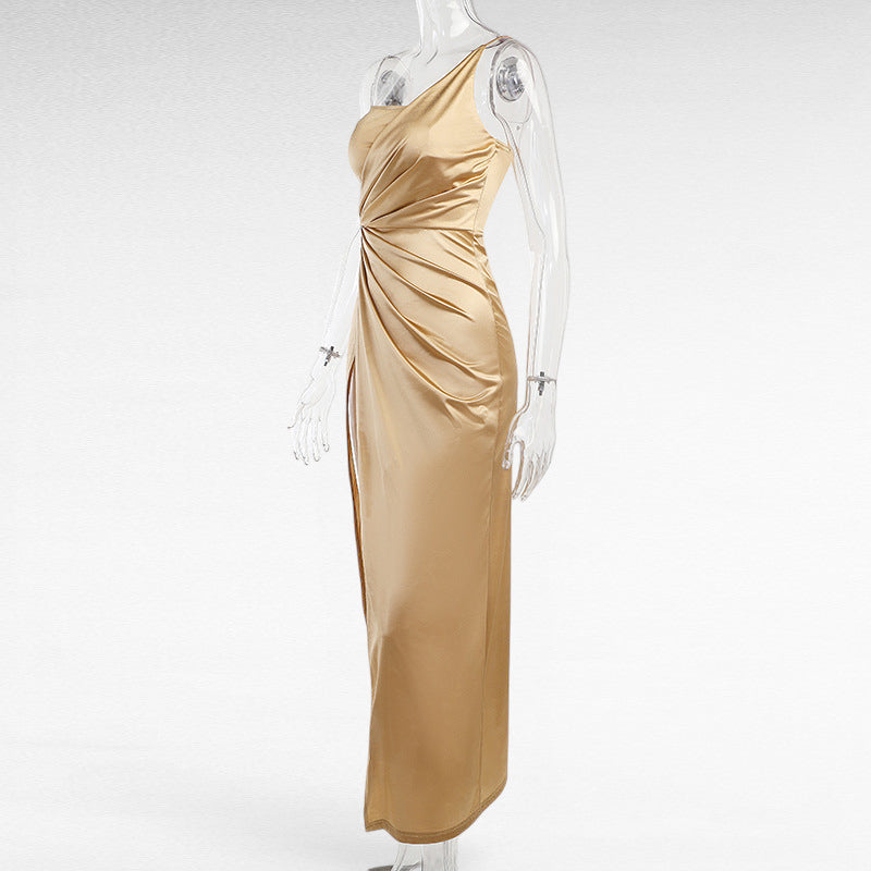 ZOFIA ATELIER gold satin woven dress with oblique shoulder, ruched detail, and high slit. Sleeveless, long swing skirt.