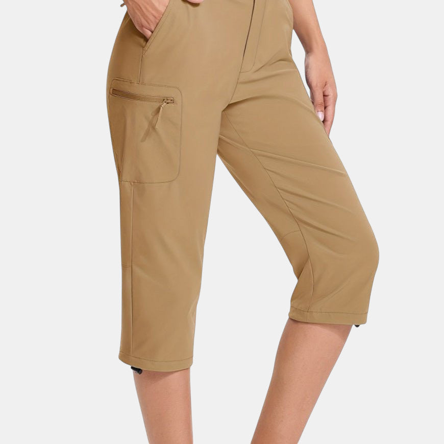 ZOFIA ATELIER Khaki PVC capri pants with asymmetric patchwork design and zippered cargo pocket.