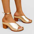 ZOFIA ATELIER MALEKA gold metallic leather square-toe block heel slide slippers with a wooden heel.