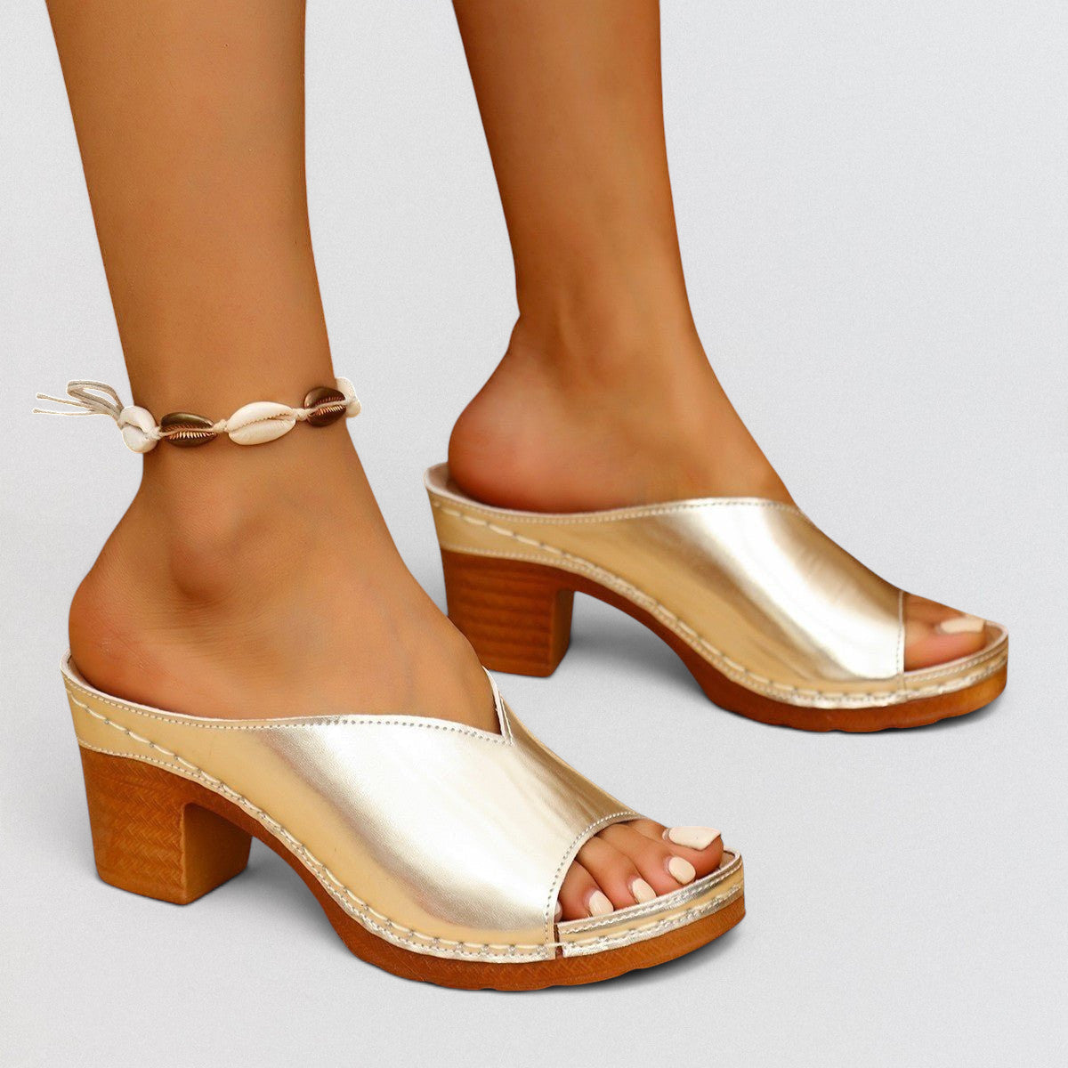 ZOFIA ATELIER MALEKA gold metallic leather square-toe block heel slide slippers with a wooden heel.