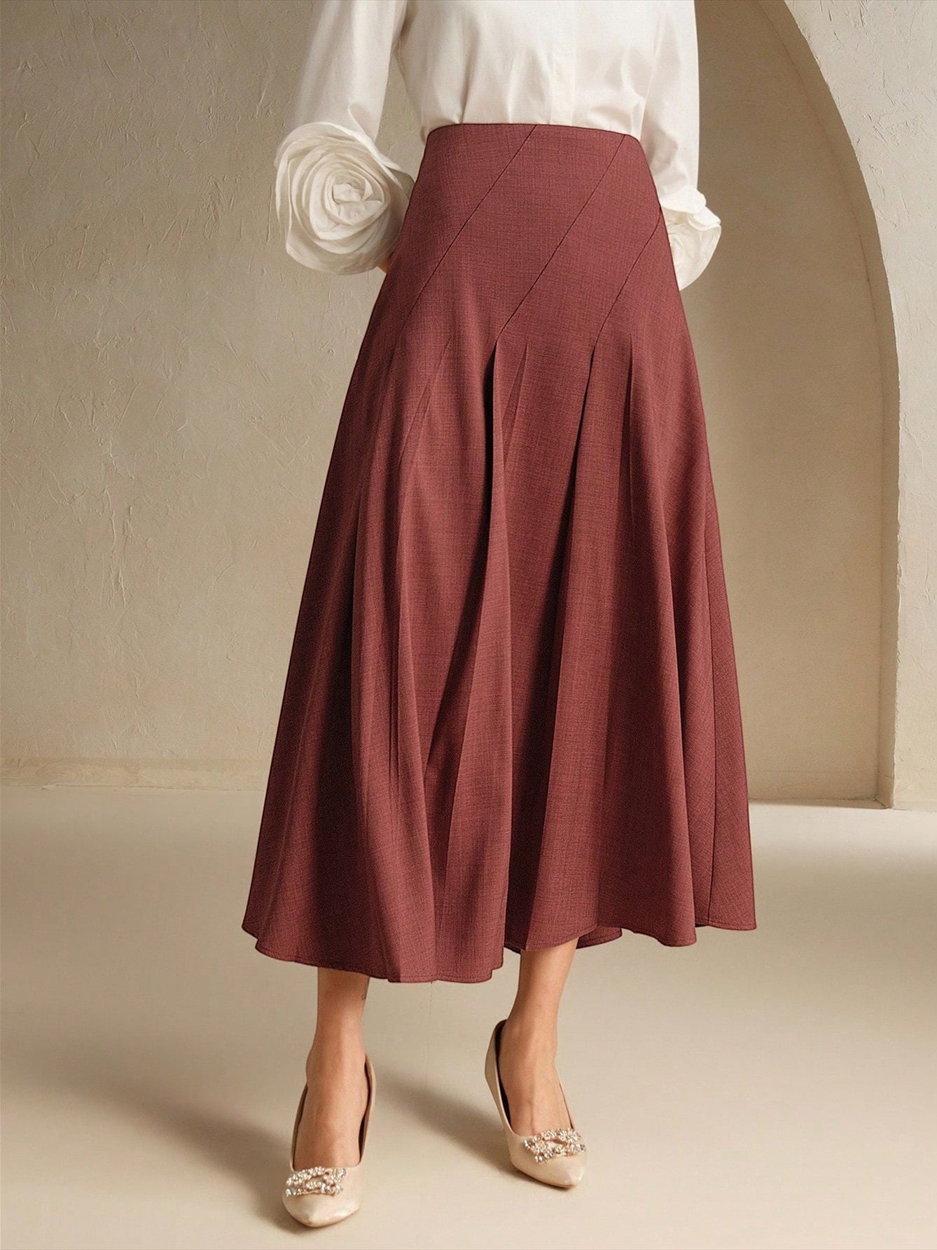 ZOFIA ATELIER LIDIA asymmetrical pleated mid-length skirt in rosewood polyester with a structured fit.