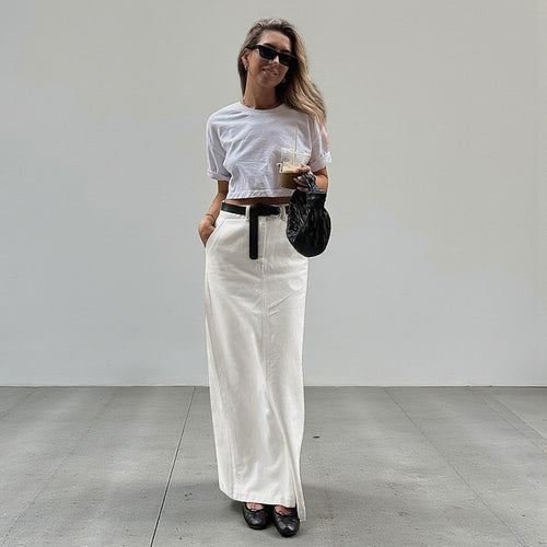 ZOFIA ATELIER white spandex A-line maxi skirt with high waist and back slit, styled casually.