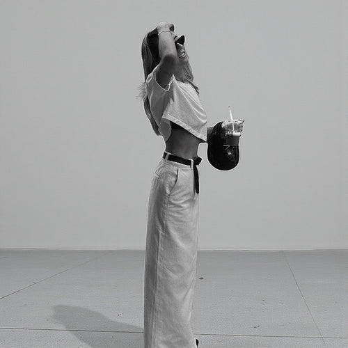 ZOFIA ATELIER white high-waist A-line spandex skirt with a back slit, worn by a model.